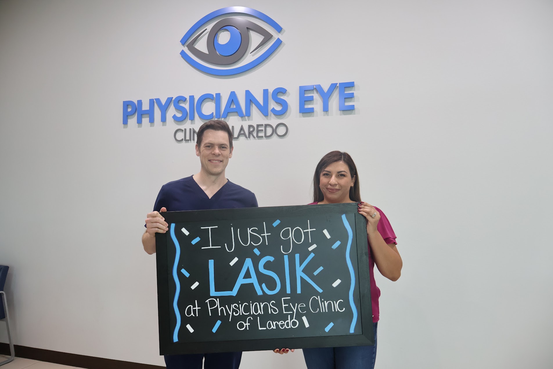 Dr. McNutt with a Physicians Eye Clinic of Laredo LASIK patient holding an 'I just got LASIK' chalkboard